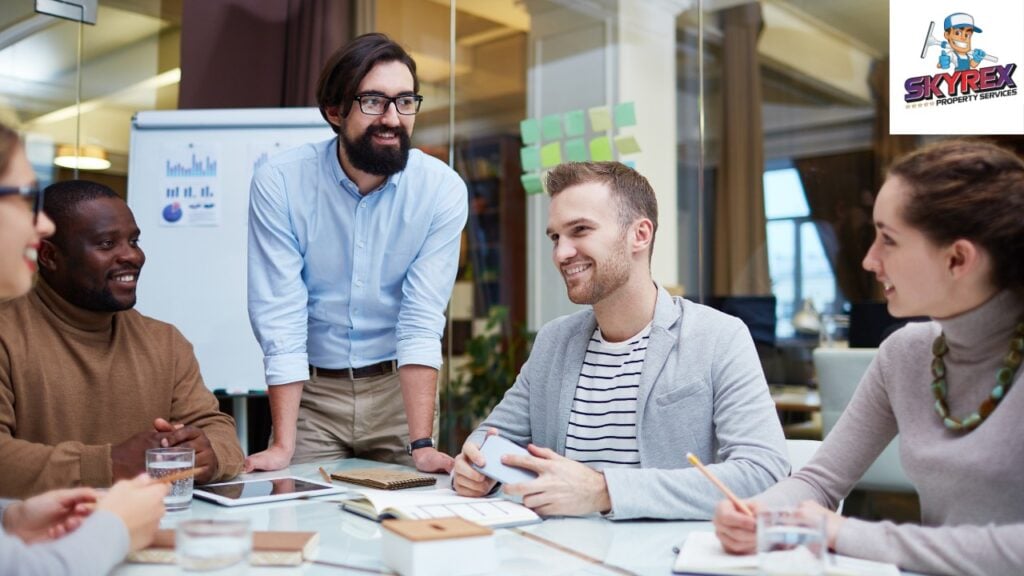 A modern, clean, bright office with smiling employees working at tidy desks