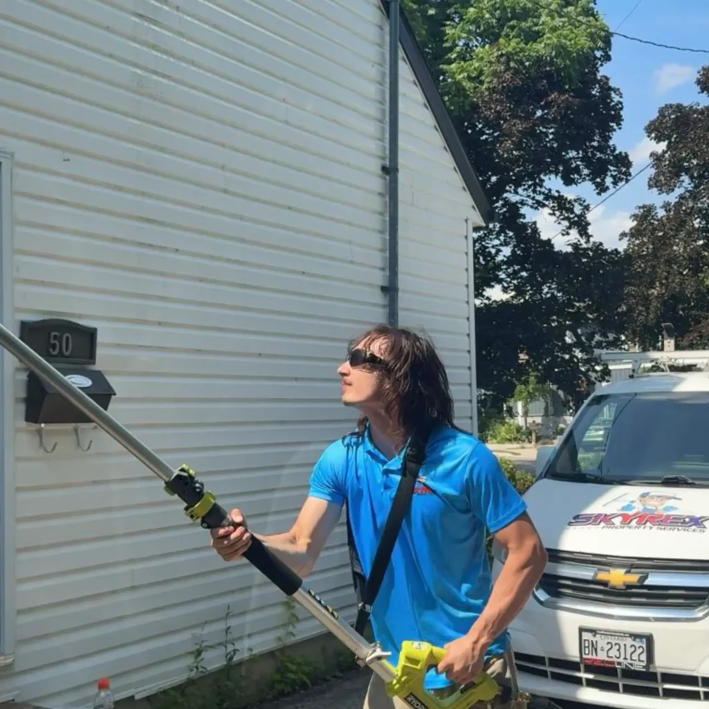 a handsome man doing professional Pressure Washing in mississauga