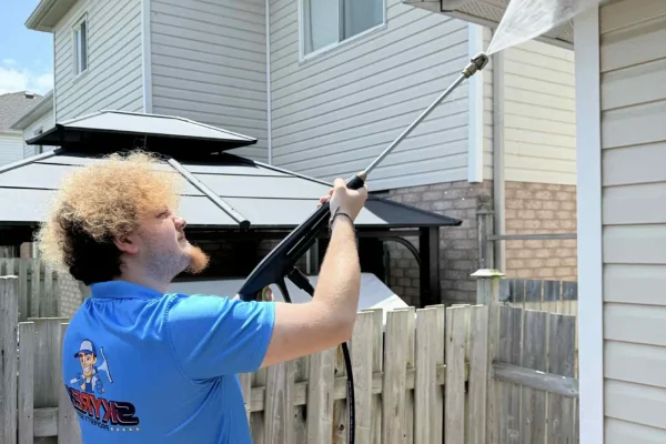 SKYREX technician pressure washing house siding in Cambridge